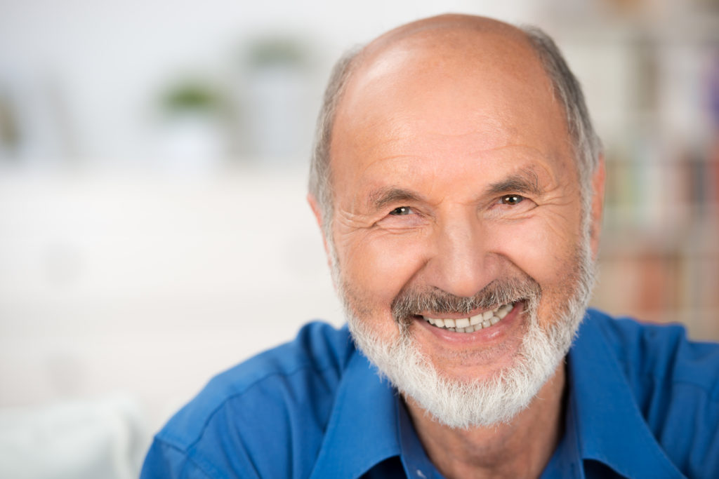 Older man smiles confidently with dentures which are part of restorative dentistry services found at Southridge Dental in Surrey, BC Canada.